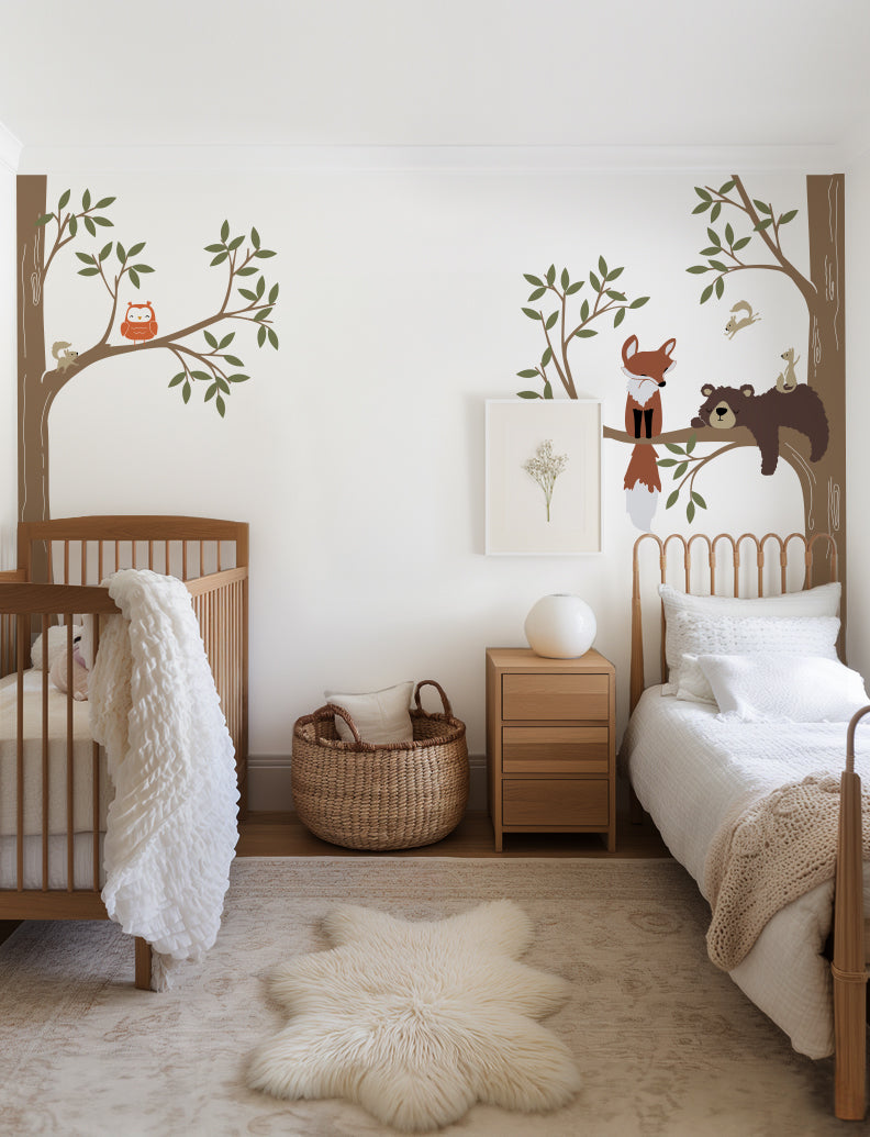 A wall decal featuring a bear, fox, owl, and squirrels in a woodland setting | www.pinknbluebaby.com