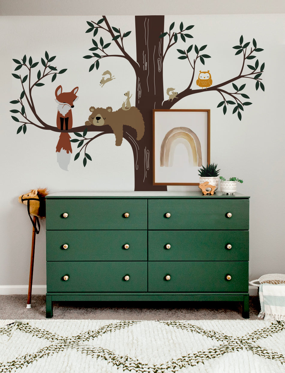 A wall decal featuring a bear, fox, owl, and squirrels in a woodland setting | www.pinknbluebaby.com