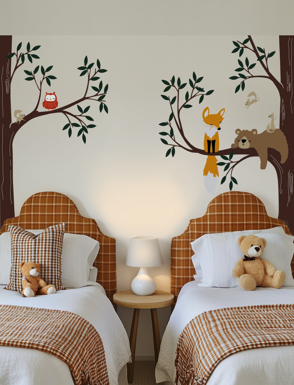 A wall decal featuring a bear, fox, owl, and squirrels in a woodland setting | www.pinknbluebaby.com